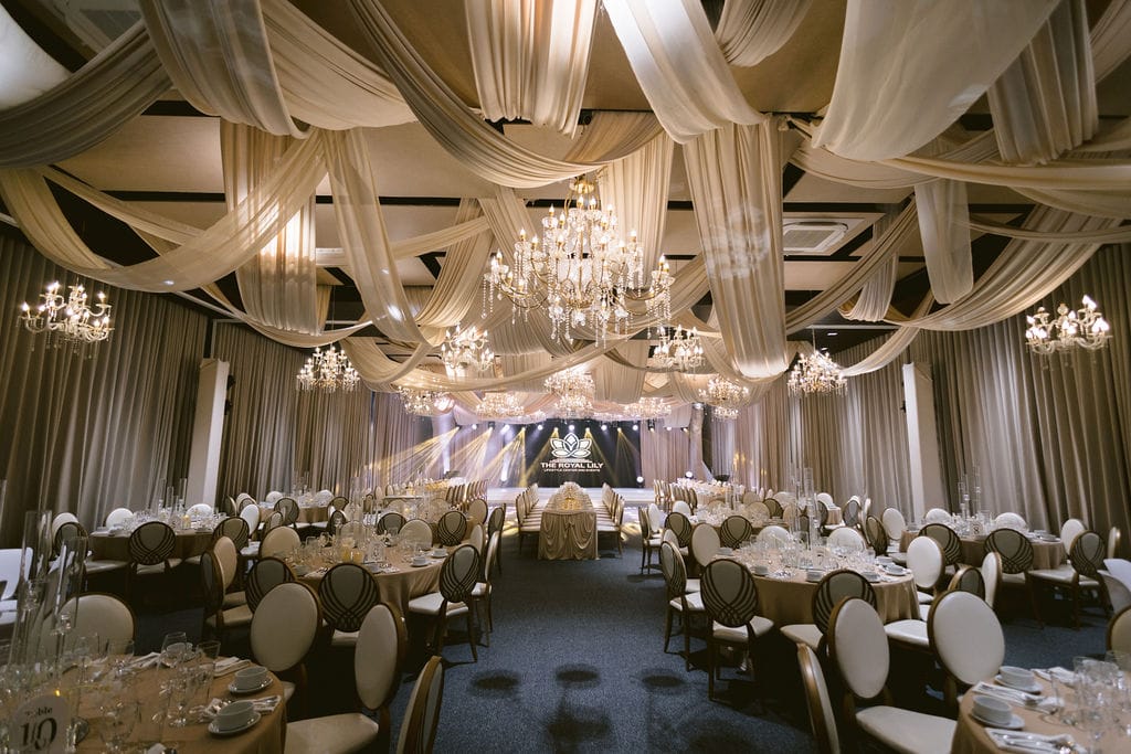 Lily Hall at night — draping, chandeliers, and the house LED wall